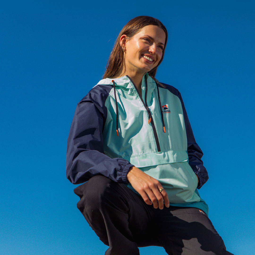 Woman against blue sky wearing a brightly coloured jacket