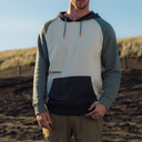 Man standing on beach in sweatshirt